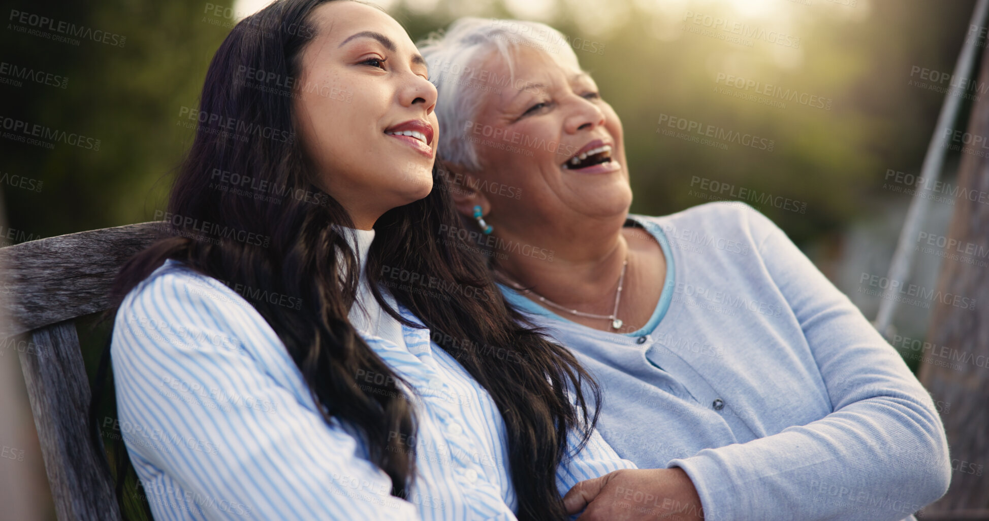 Buy stock photo Happy, senior and mother with woman on bench, nature and bonding hug for laugh on retirement. Mature person, parent and older daughter for together in park, care and love with funny joke in garden