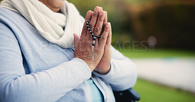 Senior, woman or hands praying with rosary for religion, worship and support for jesus christ in garden of home. Elderly, person and prayer beads for thank you, gratitude and trust in God for praise