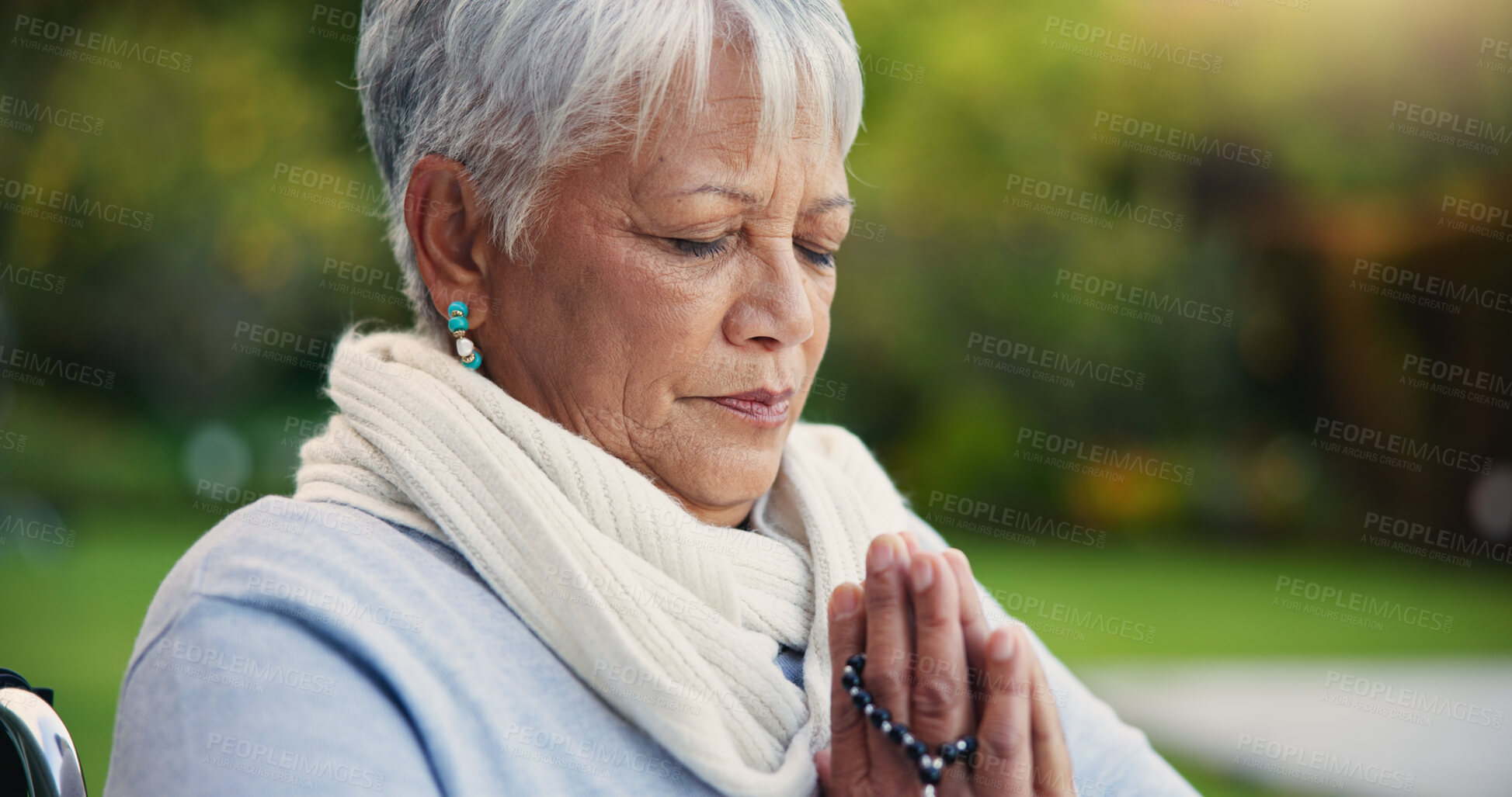 Buy stock photo Senior woman, praying hands or rosary in wheelchair in nature, faith or hope in retirement. Mature person, catholic or meditation or praise to god, garden or petition as intercessor for jesus christ