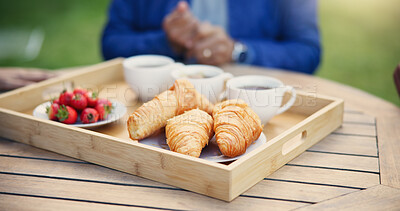 Buy stock photo Nutrition, breakfast and tray for morning, tea and fruit for diet, pastry and crossiants with strawberry, food or cup. Healthy living, fiber and beverage for thirst, coffee and fresh meal in backyard