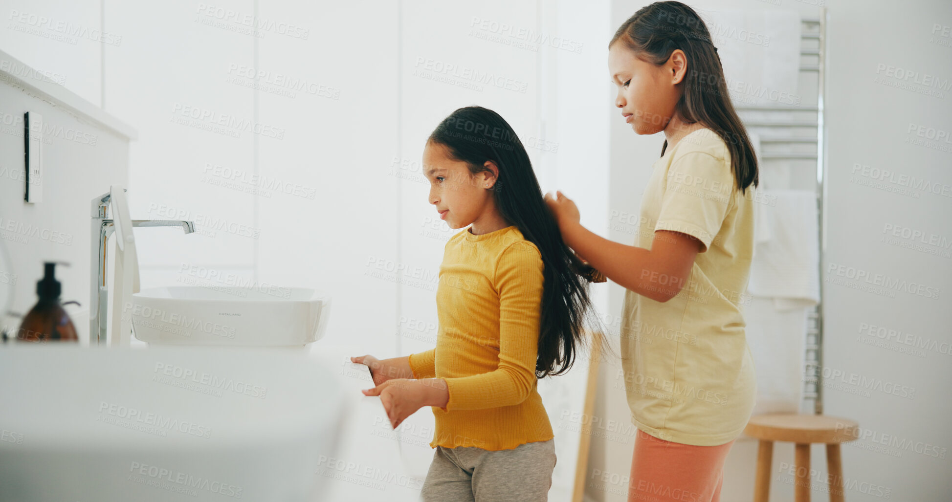 Buy stock photo Family, bathroom and a girl brushing the hair of her sister in their home for morning routine or care. Kids, beauty or haircare with a young female child and sibling in their apartment for hygiene