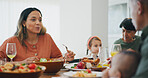 Family home, woman and thanksgiving with eating, food and talk with kid, plate and dish for festive celebration. People, conversation and together in dining room, house and child at holiday brunch