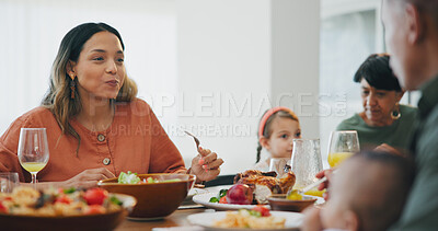 Family home, woman and thanksgiving with eating, food and talk with kid, plate and dish for festive celebration. People, conversation and together in dining room, house and child at holiday brunch