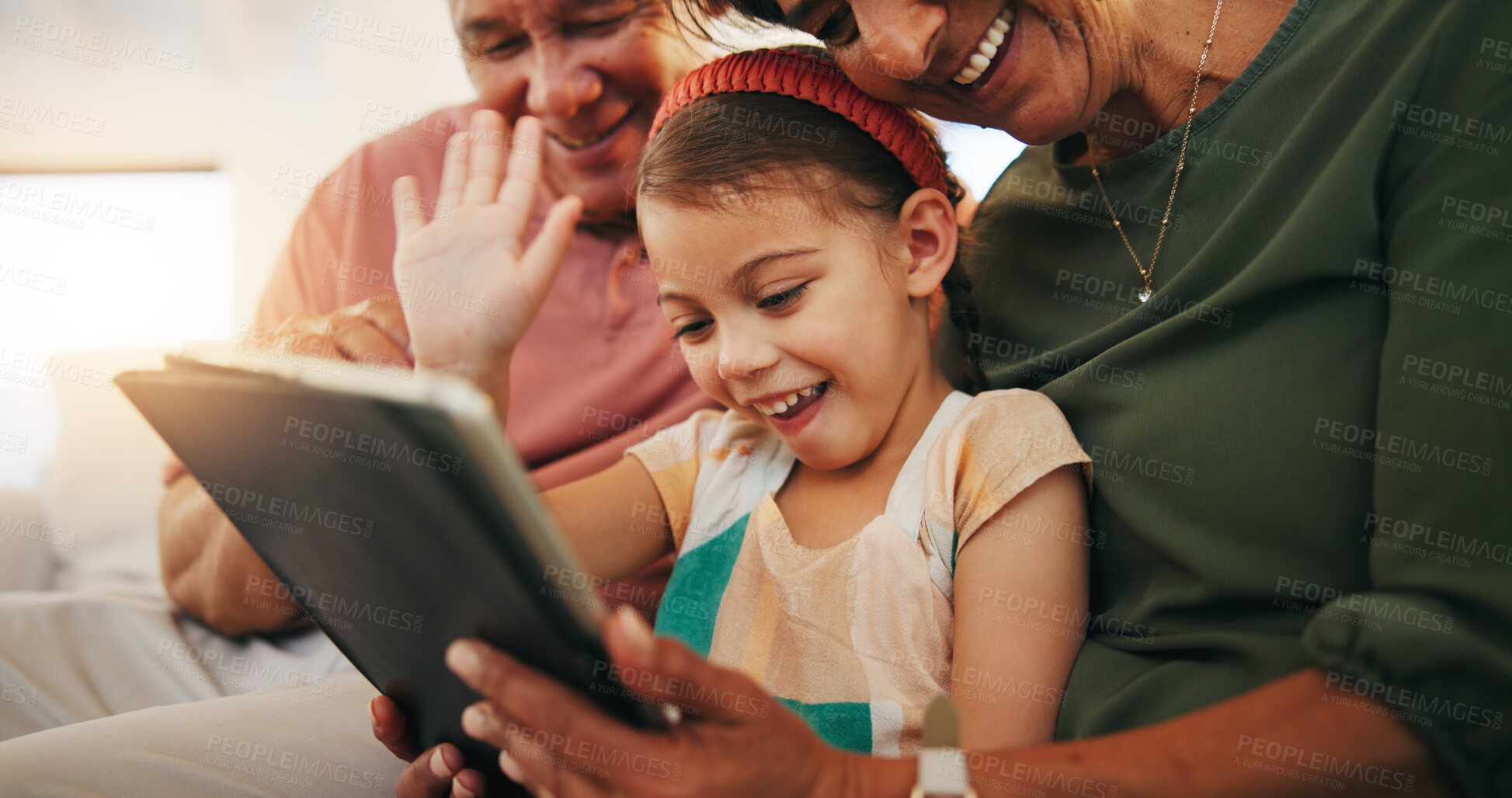 Buy stock photo Tablet, video call and child with grandparents on sofa in the living room of modern family house. Happy, virtual communication and girl on digital technology relaxing with senior people at home.