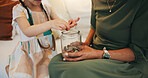 Grandparent, child and hands with money jar for savings, coins or investment together on living room sofa at home. Closeup of little girl counting cash with grandma for financial freedom or change