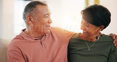 Buy stock photo Retirement, couple and hug with love in morning, home or conversation with support in living room. Mature, people and talking together with embrace on sofa in lounge of apartment or vacation in house