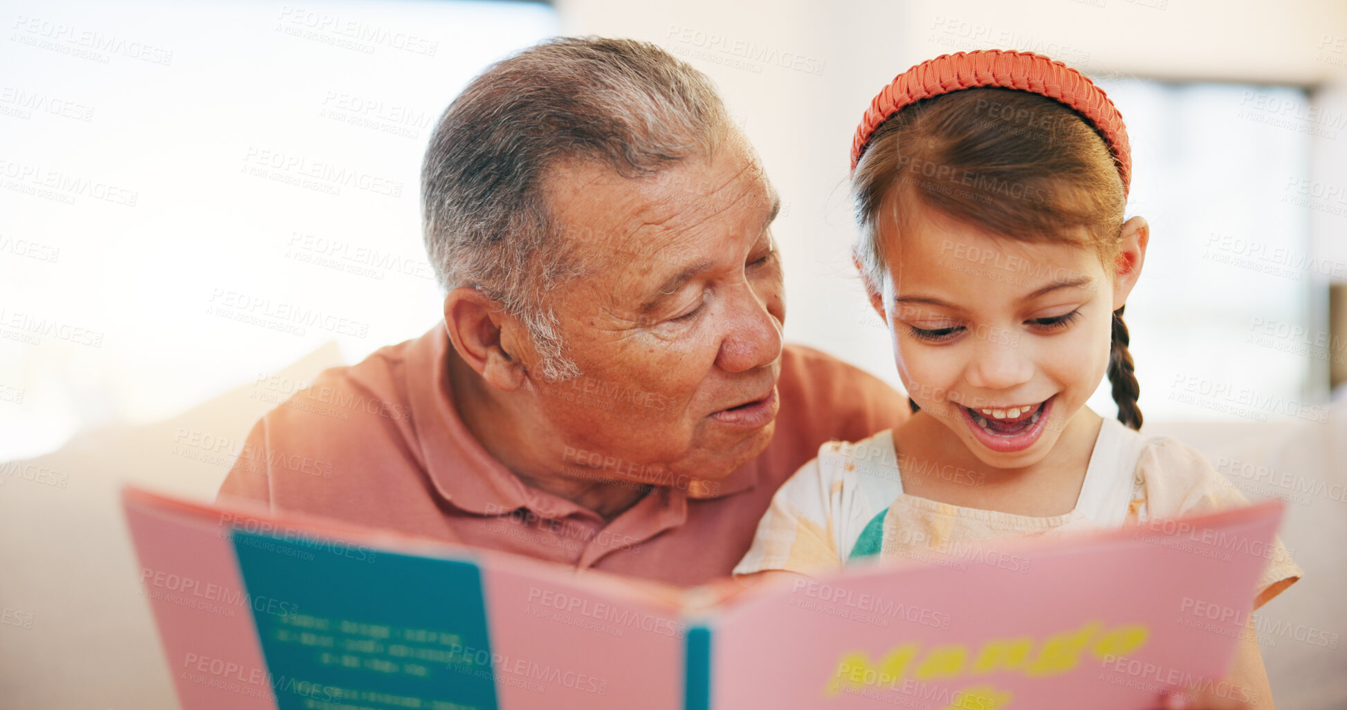 Buy stock photo Happy grandfather, child and reading book on sofa for literature, education or bonding together at home. Grandparent with little girl smile for story, learning or relax on living room couch at house