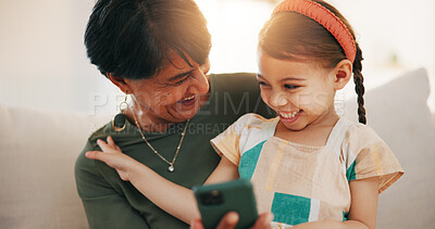 Buy stock photo Child, grandmother and cellphone laugh on sofa or online connection, games or bonding. Kid, old woman and smile for social media or funny joke embrace on couch together relax, love or trust safety