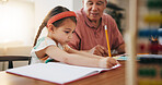 Grandfather, little girl and writing in book for learning, literature or education together on desk at home. Grandpa, child or kid taking notes in homeschool to read and write on table at house