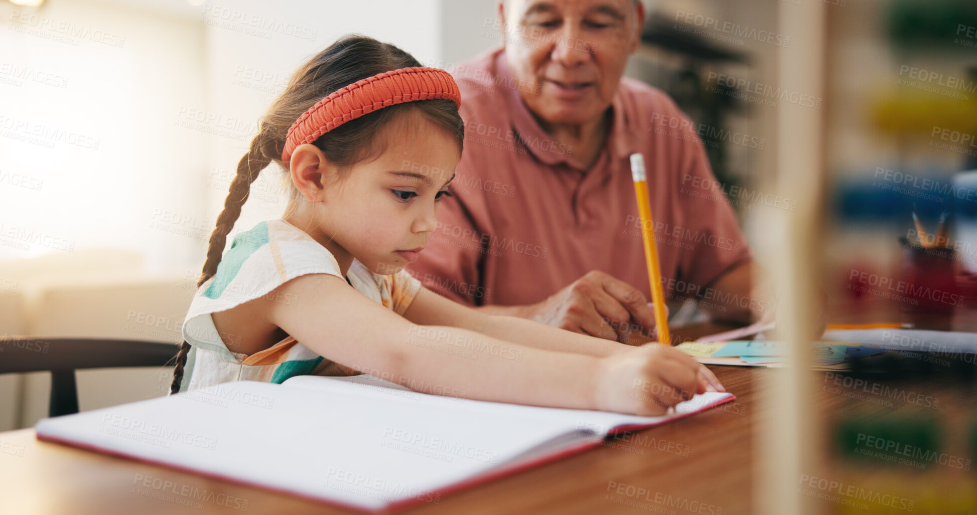 Buy stock photo Grandfather, little girl and writing in book for learning, literature or education together on desk at home. Grandpa, child or kid taking notes in homeschool to read and write on table at house