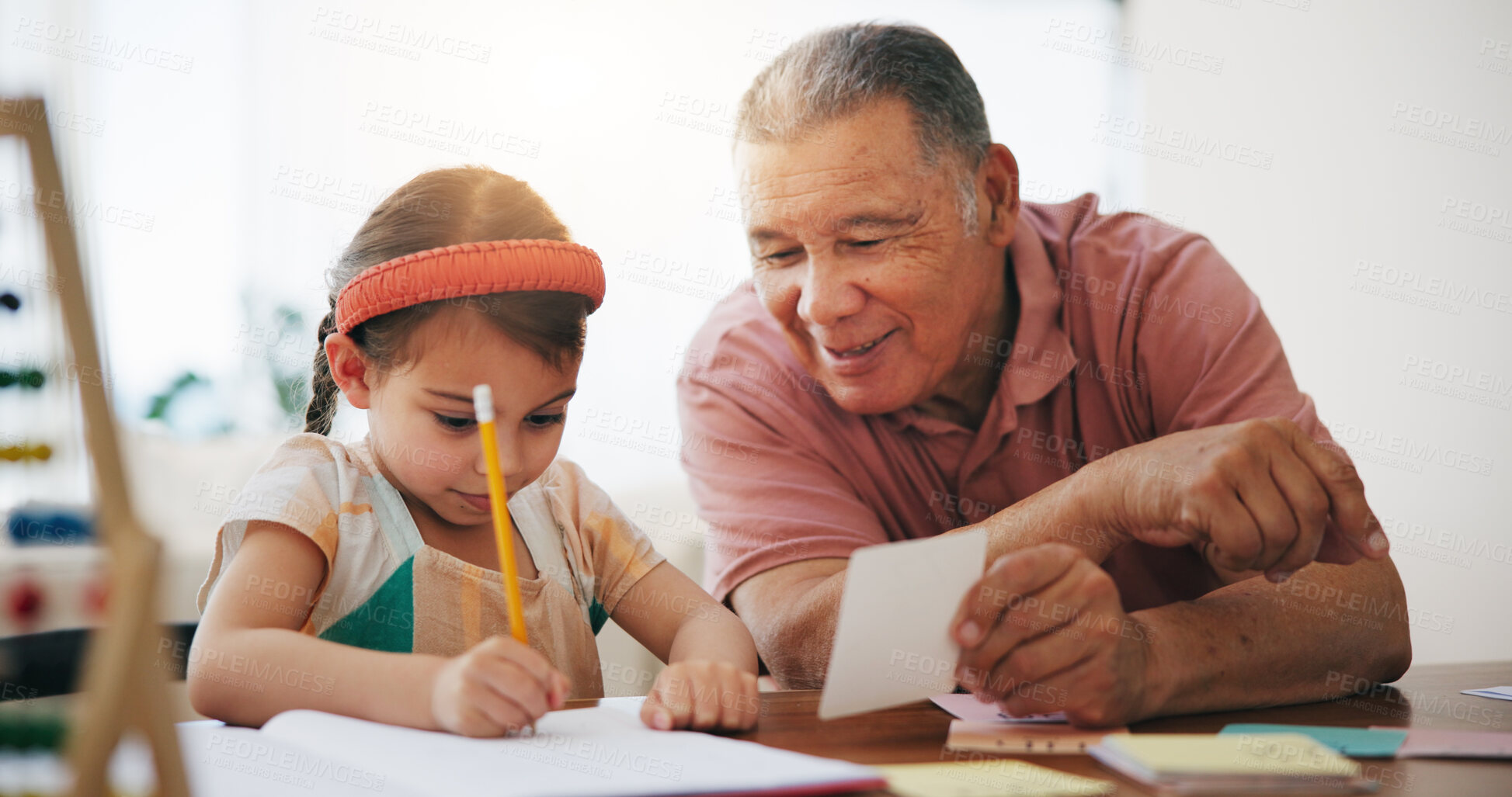 Buy stock photo Child, senior man and education or writing, book and learning at home, drawing and support or paper. Girl, grandfather and notebook or tutoring, assessment and smile for language or math homework