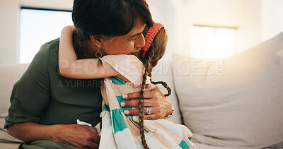 Buy stock photo Family, love and girl hugging her grandmother on a sofa in the living room of their home during a visit together. Trust, care and security with a senior woman embracing her grandchild in an apartment