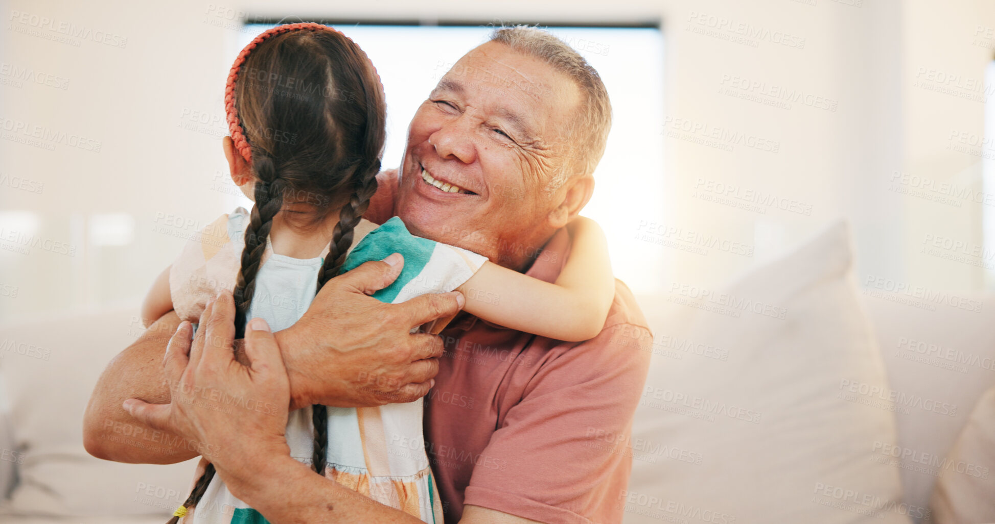 Buy stock photo Grandfather, child and hug on sofa in living room for love, care or bond with lens flare. Elderly man, happiness and smile for little girl for moment, memories and support while babysitting at home