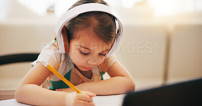 Buy stock photo Child, writing and headphones for home education, e learning and online class on computer with audio. Girl or kid listening to virtual school, homework notes and language, translation or creativity