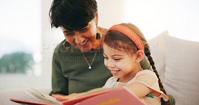 Buy stock photo Grandparent, kid and reading book with smile, home and child development, grandchild and couch. Woman, lounge or bonding together for relationship, family and retired with girl, house and happy
