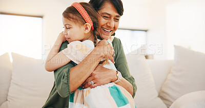 Buy stock photo Grandmother, child and hug on sofa in living room for love, care and bond for relationship. Senior woman, little girl and smile in happiness for memory, moment or support while babysitting at home