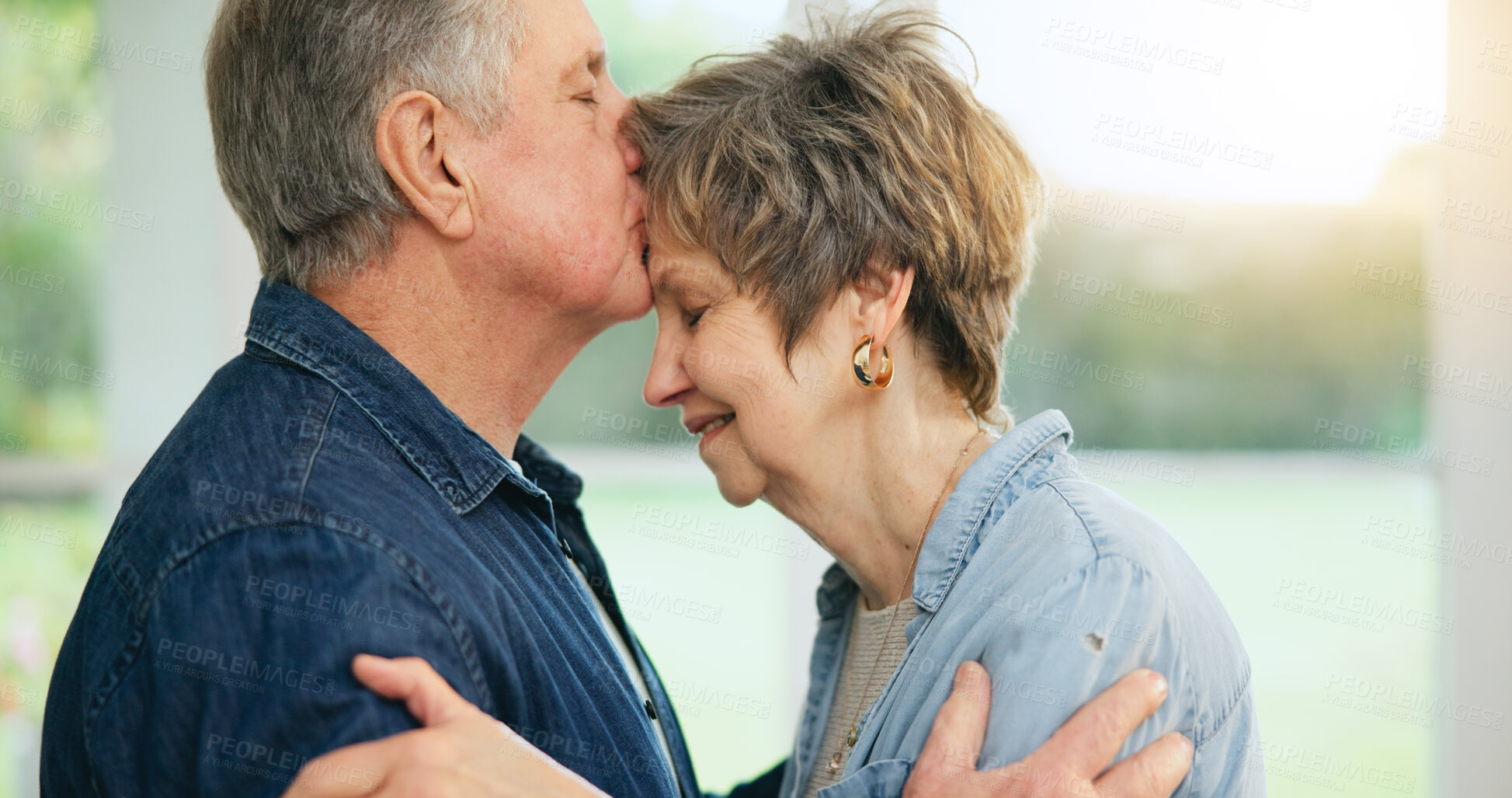 Buy stock photo Senior couple, forehead or kiss of love in support, loyalty or commitment in retirement in family home. Mature man, woman or marriage in gratitude for together in trust, security or care in apartment