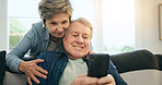 Senior, couple and hug with phone or happy for social media, streaming or internet scroll on sofa of living room. Elderly, woman and man with smartphone on couch in lounge for digital app and smile