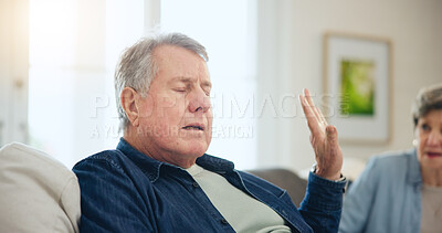 Buy stock photo Senior, couple or stress with conflict and fight on sofa in living room of home with hand for stop. Elderly, man or woman with argument, upset and frustrated on couch in lounge of house or ignore