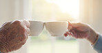 Elderly couple, hands or tea toast in house to enjoy bonding, love or celebration together in retirement. People, coffee drink or man at nursing home to relax with a senior woman on break by window