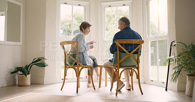 Buy stock photo Home, retirement and coffee with senior couple, conversation and discussion with love, bonding together and speaking. Apartment, sunshine and elderly woman with old man, talking and marriage with tea