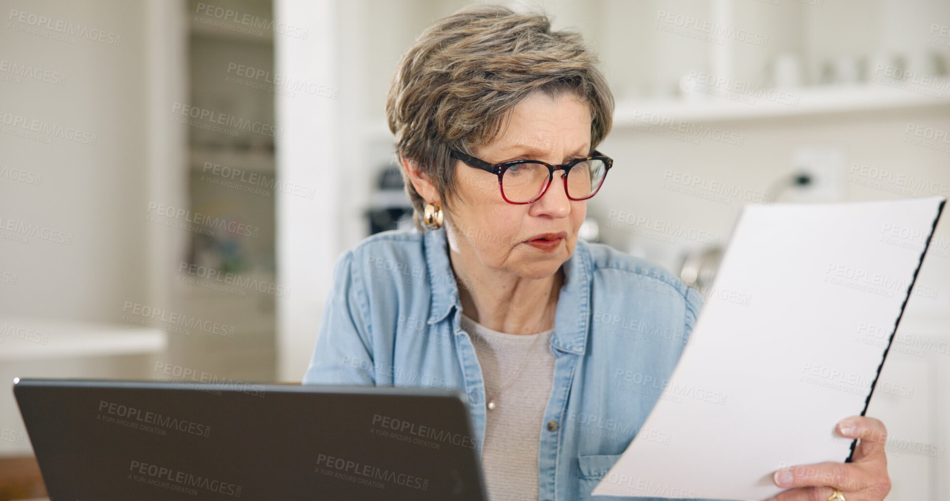 Buy stock photo Senior woman, laptop and documents for finance, budget planning or expenses in living room at home. Mature female person busy with paperwork on computer for financial investment, bills or mortgage