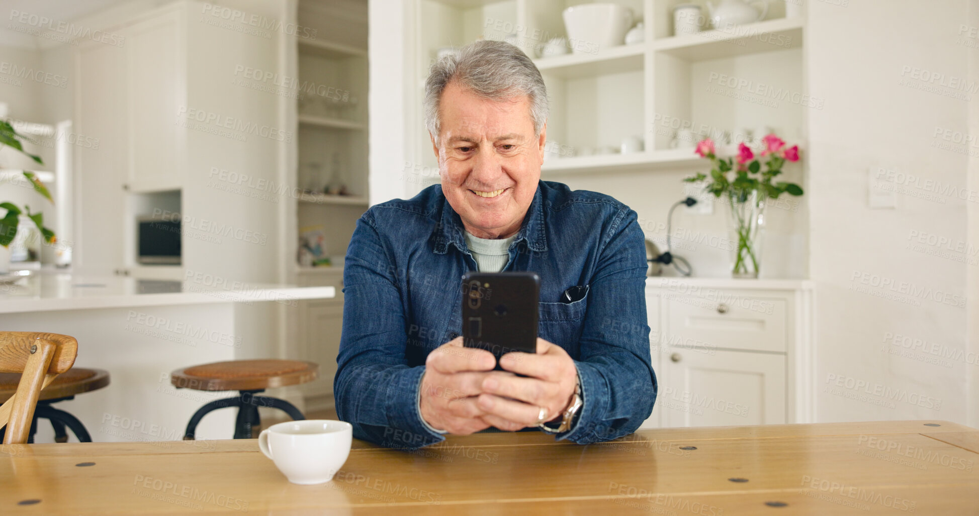 Buy stock photo Happy senior man, phone and social media in relax for communication or networking in kitchen at home. Mature male person smile on mobile smartphone for online chatting, texting or search at house