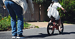 Dad, child and teaching bicycle ride for safety, outdoor street and having fun learning to cycle. Cycling, childhood memory and riding in summer with helmet, bonding together and recreation activity