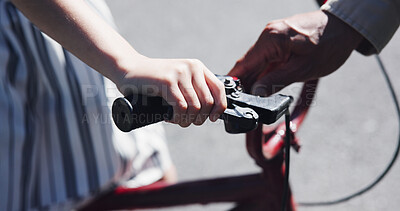 Buy stock photo Closeup, child and teaching bicycle ride for safety, parent and neighbourhood with hands. Cycling, childhood memory and riding in summer, bonding together and handlebar with bike bell for alert