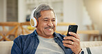 Senior, happy man and headphone for video call in living room by internet, web or app. Elderly person, smile and technology for connectivity, cellular or network with mobile for communication in home