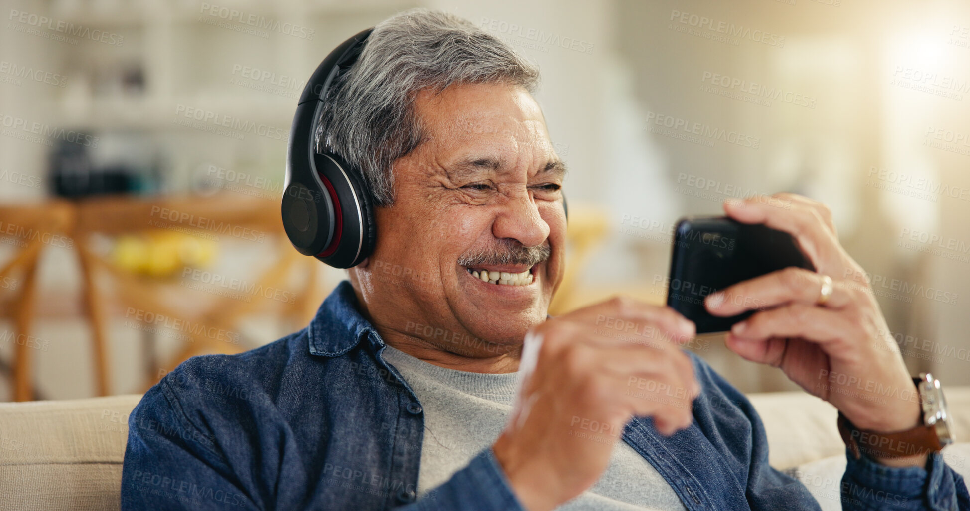 Buy stock photo Senior, man and headphone with phone in home for streaming, online and mobile app. Elderly person, smile and excitement for technology with connection, cellular or network for entertainment on web