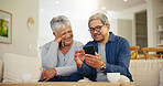 Senior couple, smartphone and social media with smile, conversation and living room sofa. Grandparents, technology and communication with family, man and woman in retirement, happy and connection
