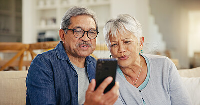 Buy stock photo Senior couple, smartphone and video call in living room sofa, conversation and joyful. Grandparents, technology and communication with family, man and woman in retirement, happy and connection
