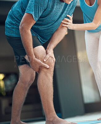 Buy stock photo Shot of a mature man grabbing his leg in pain after an intense workout with his wife