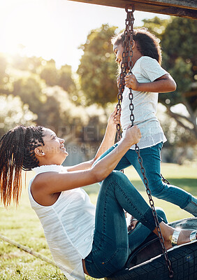 Buy stock photo Mother, daughter and happy on swing at park, fun and playing together with smile outdoor. Love, care and bonding with family happiness, woman and girl enjoy time at playground with freedom in nature