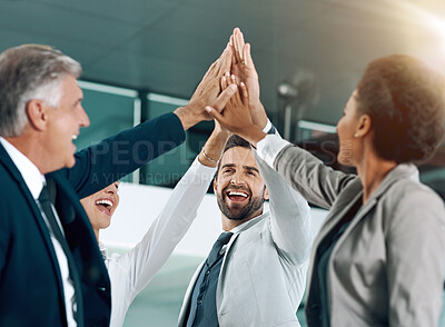 Buy stock photo Shot of motivated work colleagues smiling and celebrating with a high five