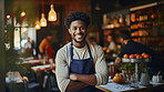 Waiter, male and portrait of a happy man standing arms crossed in a restaurant kitchen. Confident, skilled and professional worker looking at camera for owner, career or hospitality occupation
