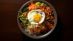 Traditional, Korean, bibimbap dish in a bowl for chef, fine dining and dinner ideas. Food photography, meal and cuisine closeup for wellness, health restaurant and cultural on a dark background