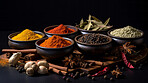 Herbs, spices and Indian seasoning for cooking and traditional cuisine or food. Colourful, fresh and dry spice set for chefs, culture and organic recipe ingredients on a black studio background