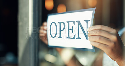 Buy stock photo Open sign, restaurant window and hands of person, small business owner or manager with cafe door poster for welcome. Retail sales waitress, coffee shop barista and closeup board for store service