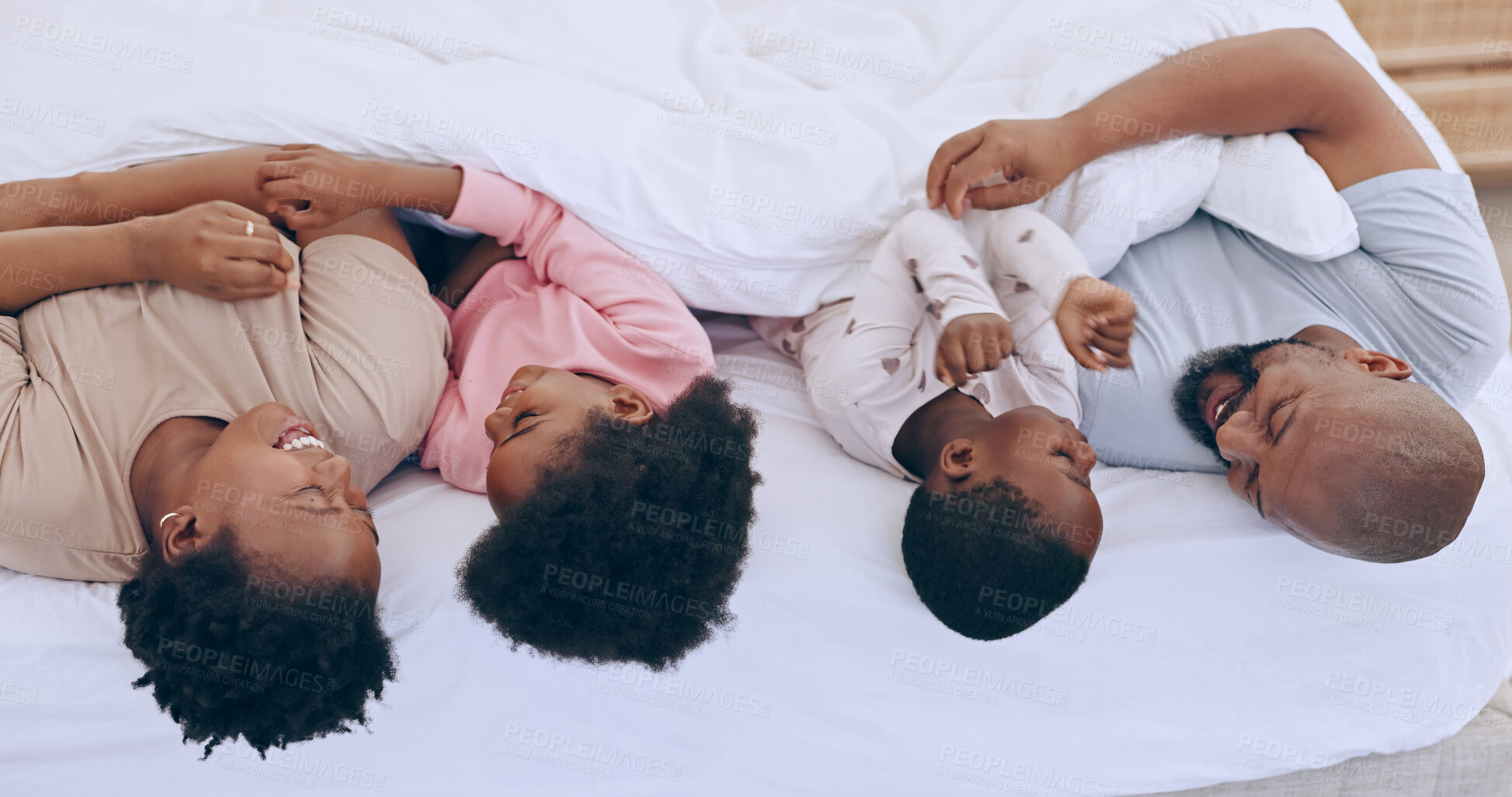 Buy stock photo Bed, relax and black family parents, happy kids or people bonding, care and love for young, mom and dad. Home, morning and African children, father and mother support, comfort and smile in bedroom