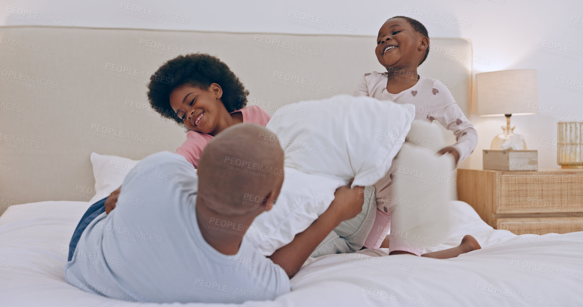 Buy stock photo Bedroom, pillow fight and black family father, happy kids or people bonding, fun and papa playing with young youth. Home, games and African children, dad and girl energy, morning and excited on bed