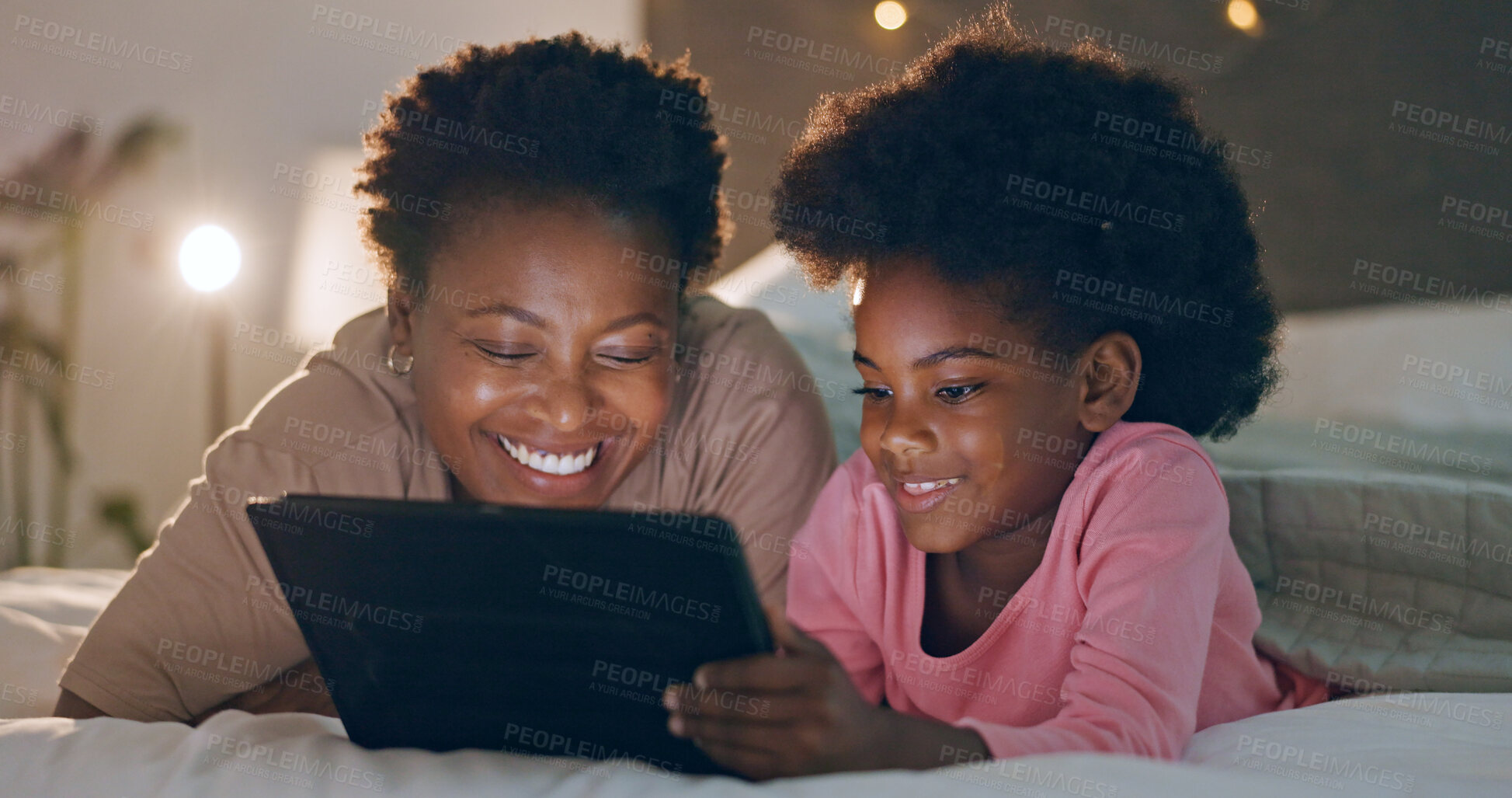 Buy stock photo Mom, child and tablet in bedroom, watching cartoons and night time in bed, technology and laugh. Happy, enjoying and online for videos, digital and internet in home, streaming or bonding together
