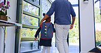 Father, child and back to school at door, walking in home and leave to start learning. Dad, kid and girl with backpack for first day, education or care, support of student with bag and hands together