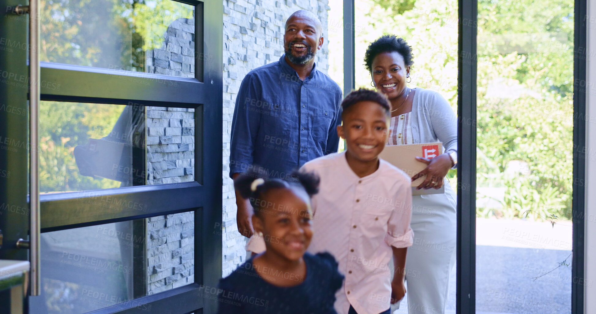 Buy stock photo Moving, black family in new home with children, boxes and smile at front door with property mortgage. Mother, father and happy kids in house, excited for investment, real estate and future together.