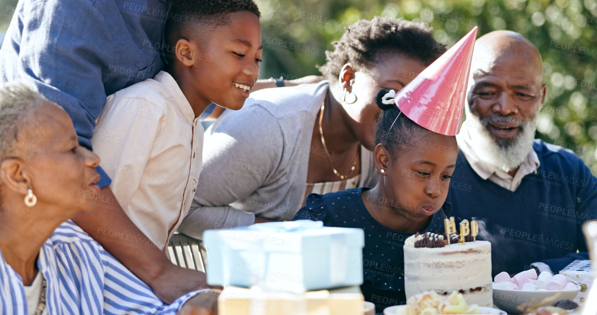 Buy stock photo Child, cake or black family in nature for a happy birthday, celebration or support with grandparents. Candles, blow or excited African people with gift, love or kids in a fun party, backyard or park