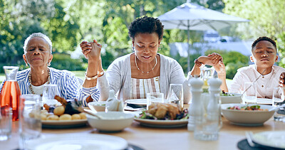 Buy stock photo Holding hands, black family or kid praying for food to worship God together for faith or gratitude. Grandmother, backyard or African mom with child in nature for a meal, brunch or lunch with grace