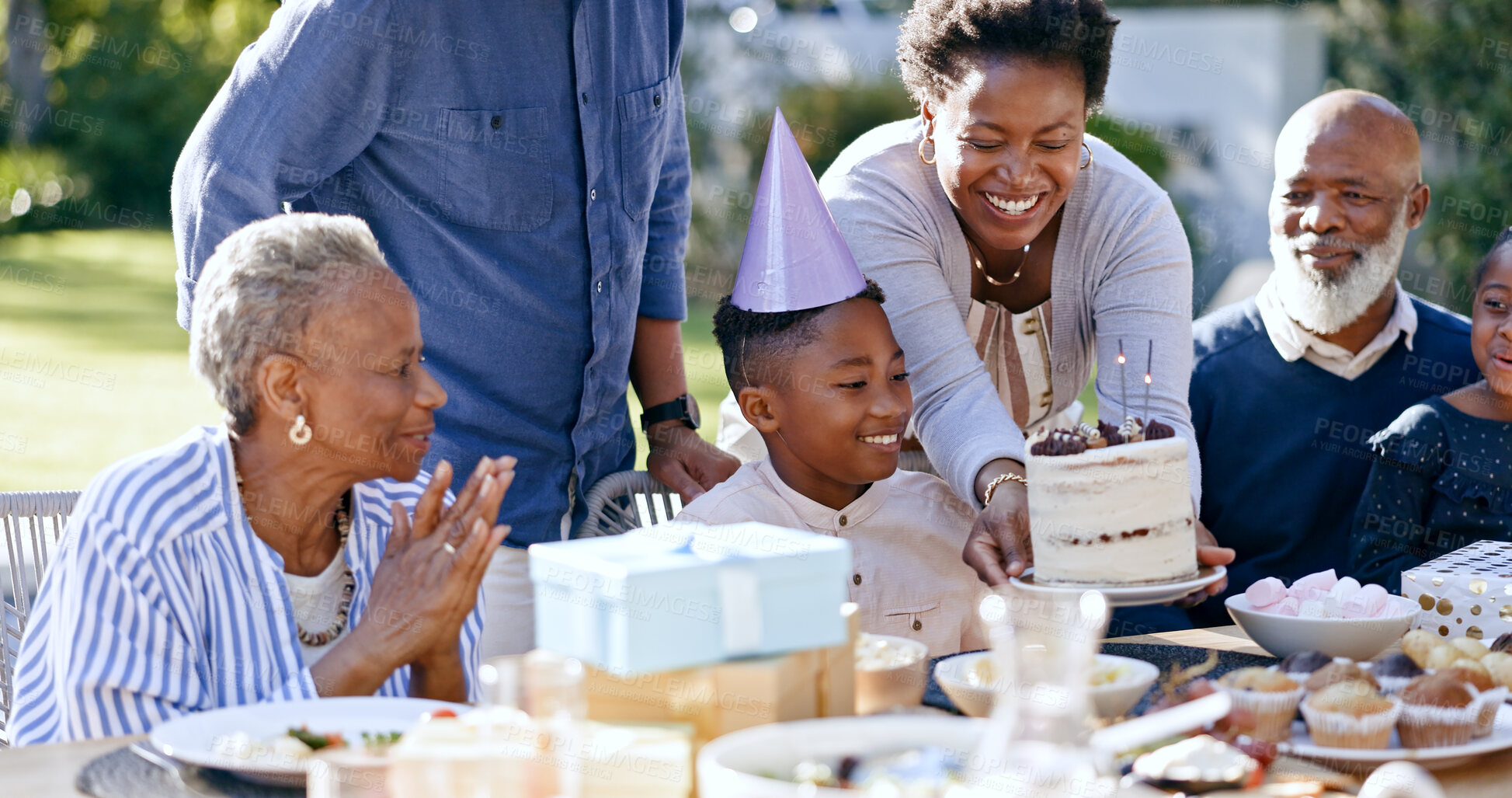 Buy stock photo Backyard, birthday and party with black family, celebration and singing with joy, event and happiness. Grandparents, mother and father with children, kids and present with love, cake and outdoor