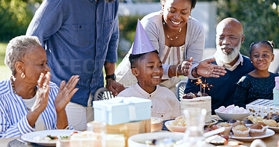 Buy stock photo Black family, birthday party and clapping for a boy child outdoor in the yard for a celebration event. Kids, applause and milestone with a group of people in the garden or backyard together in summer