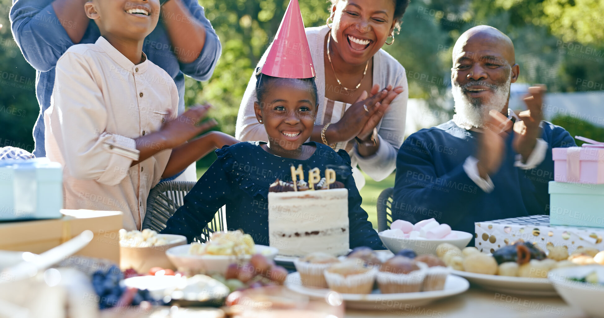 Buy stock photo Family, birthday and applause at party with cake, celebration and excited or smile together in home. African parents, kids and clapping at event table outdoor with food, dessert and congratulations